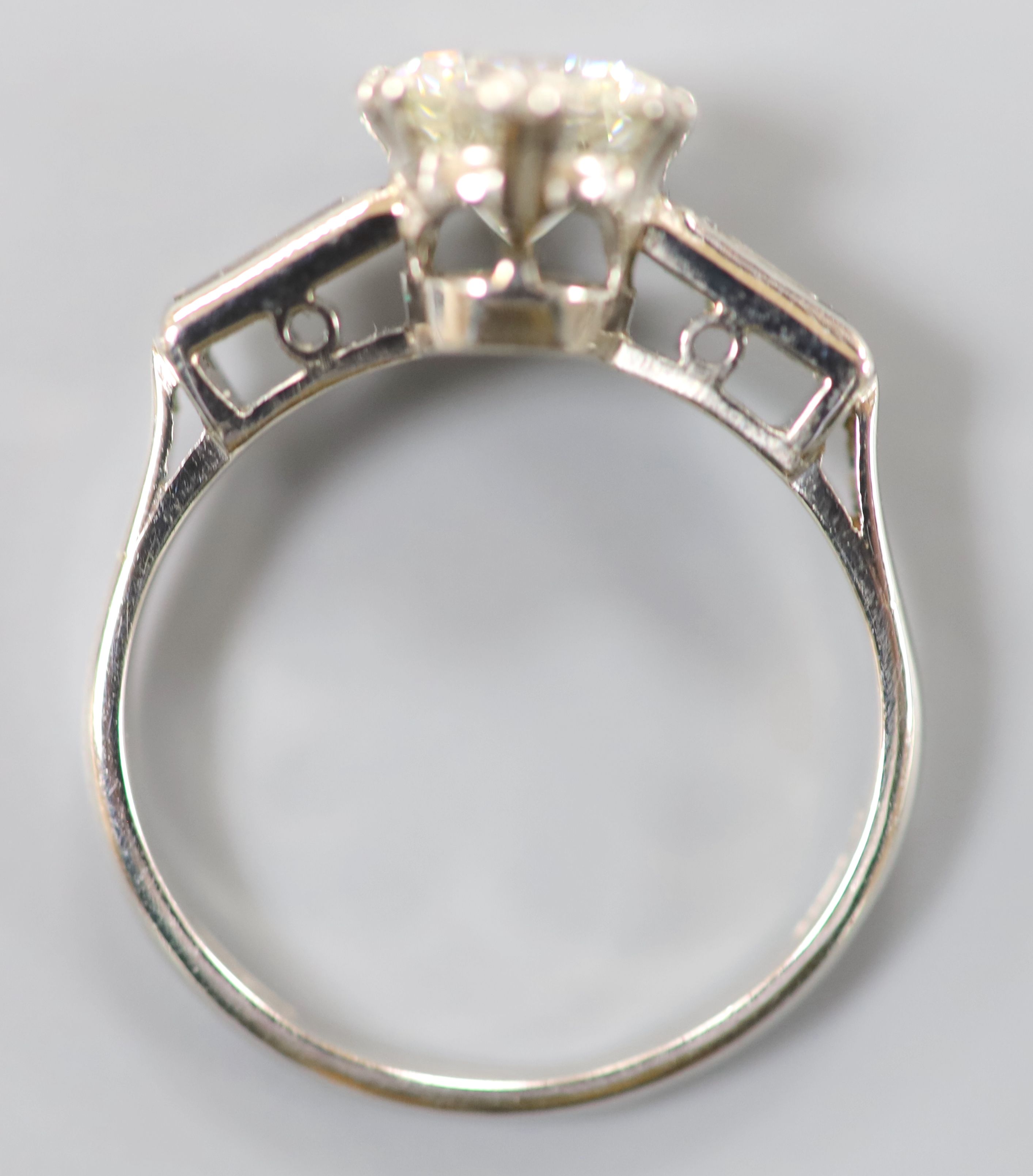 A modern platinum and single stone diamond ring,